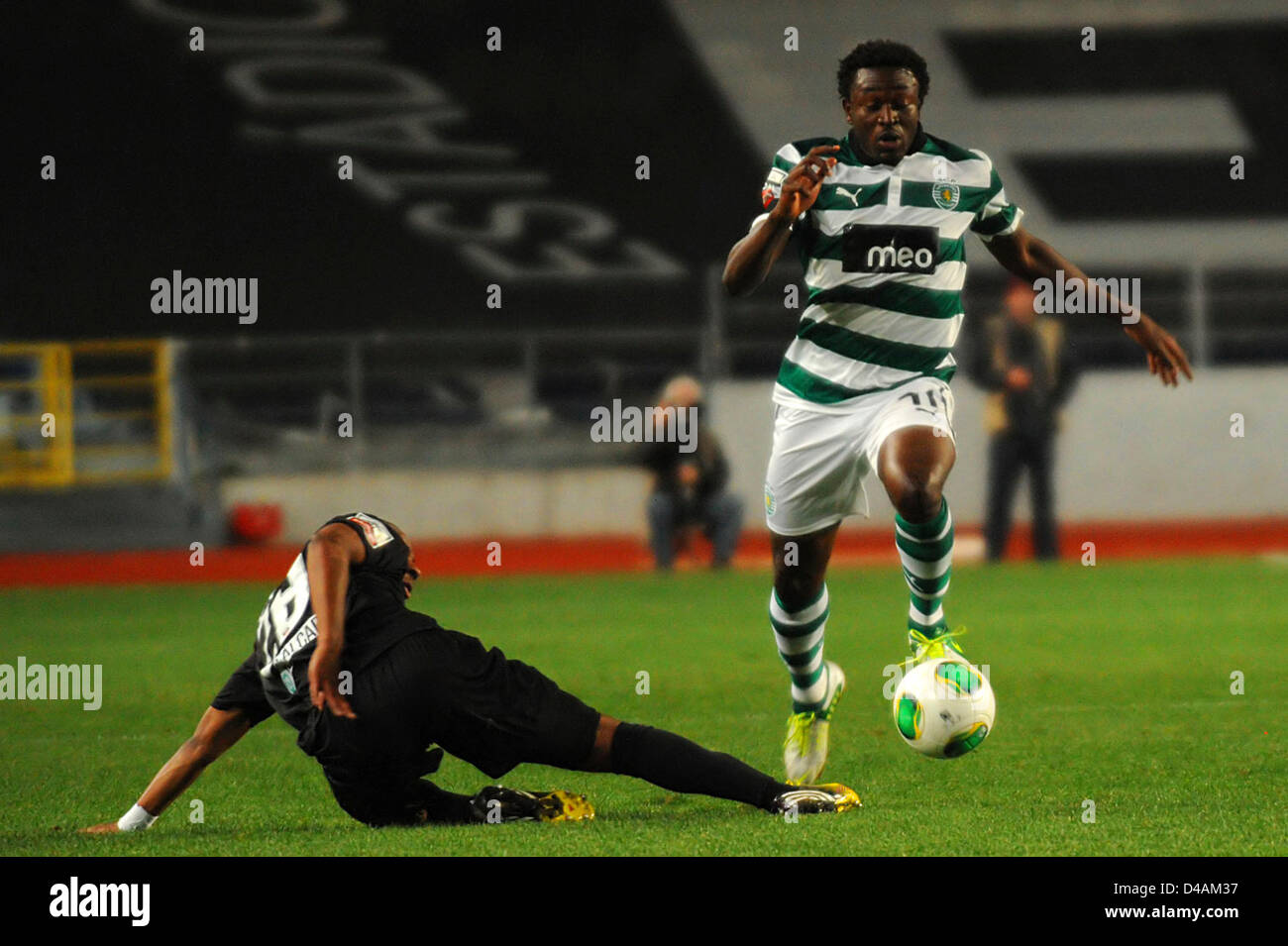 An Academica defender fails to tackle Sporting Clube de Portugal player Fokobo during a Portuguese football league match Stock Photo