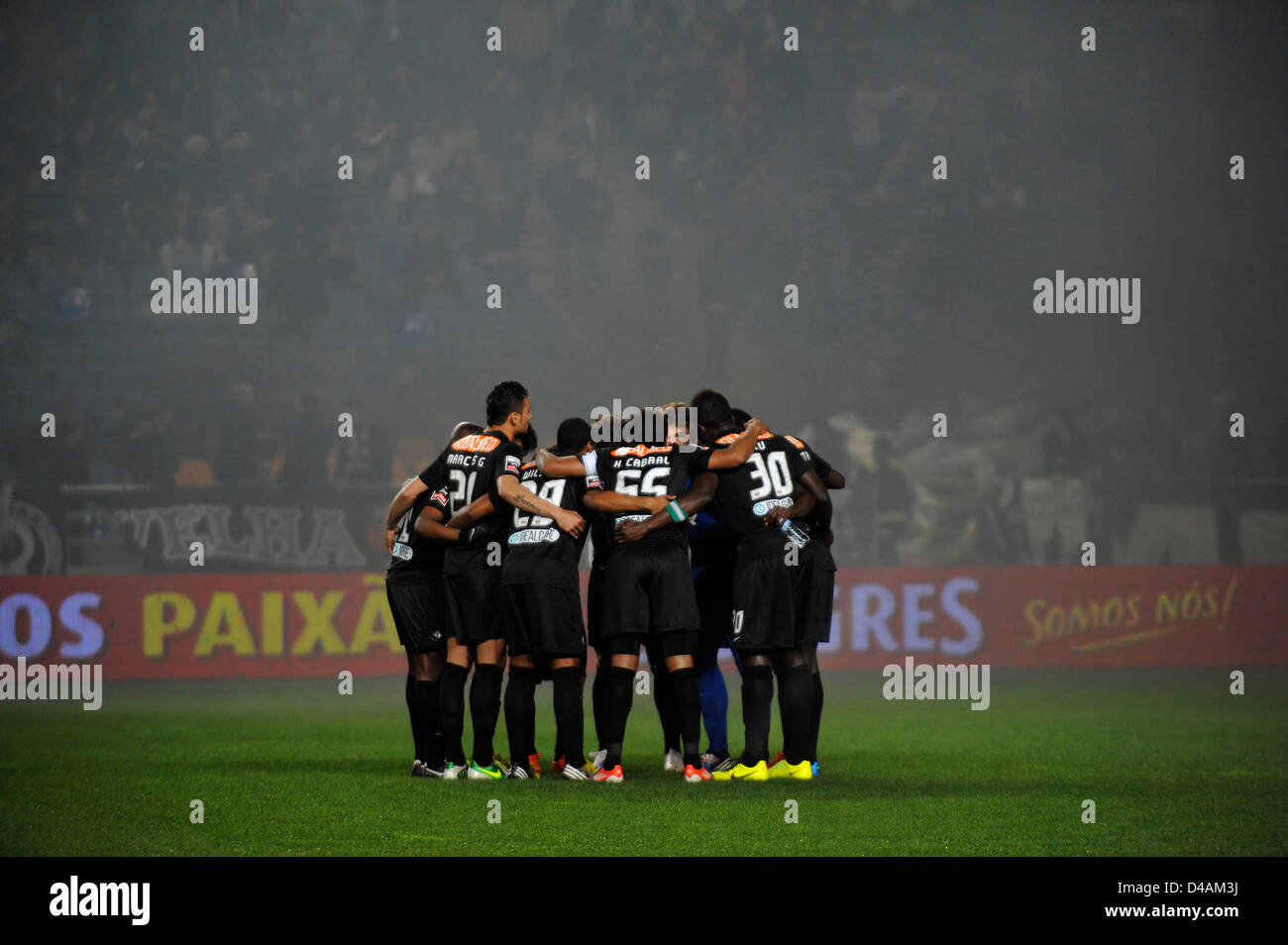 Football players huddle up before a match Stock Photo