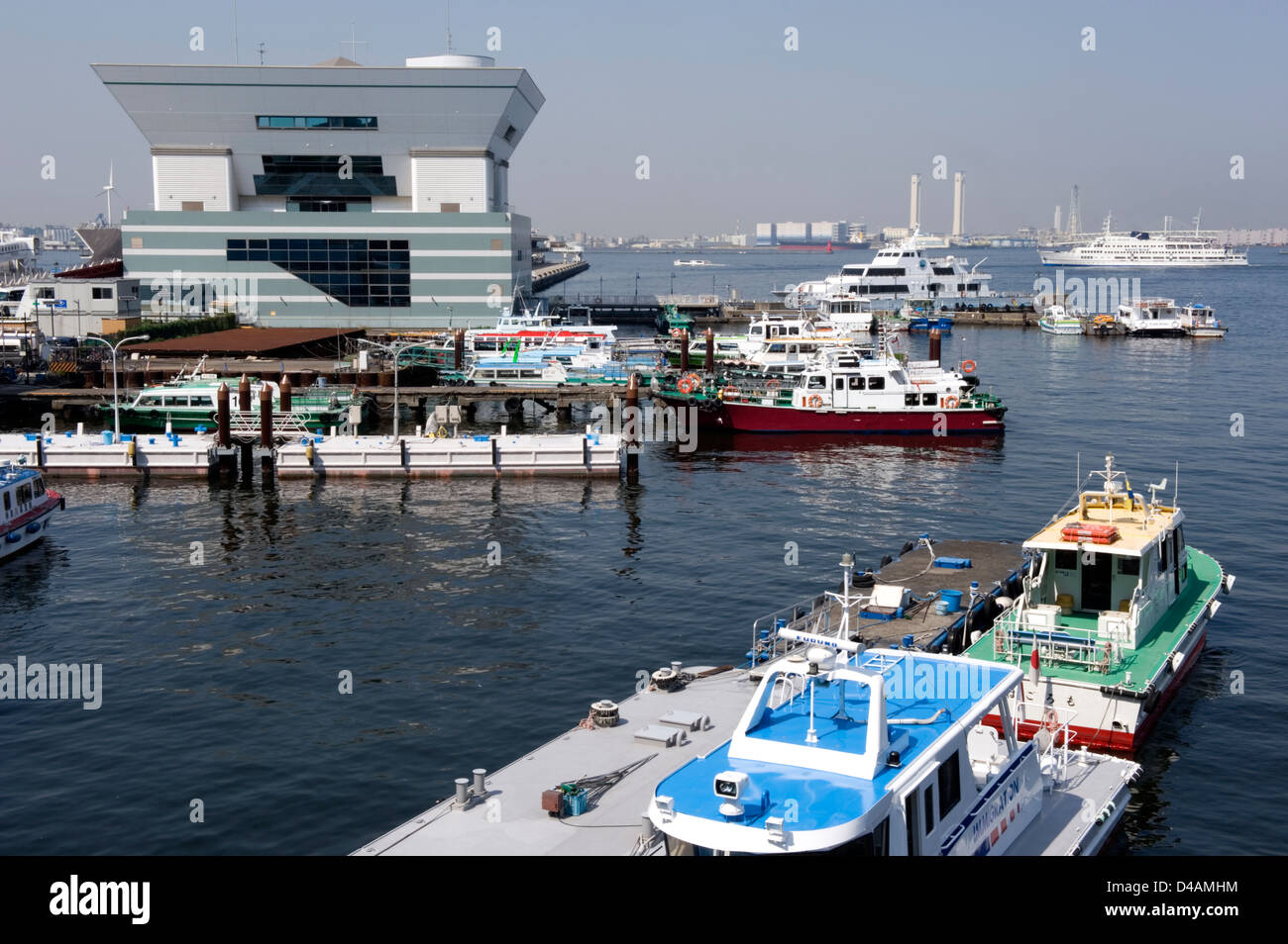 The modern International Passenger Terminal building on Osanbashi Pier dominates the busy waterfront of Yokohama, Japan. Stock Photo