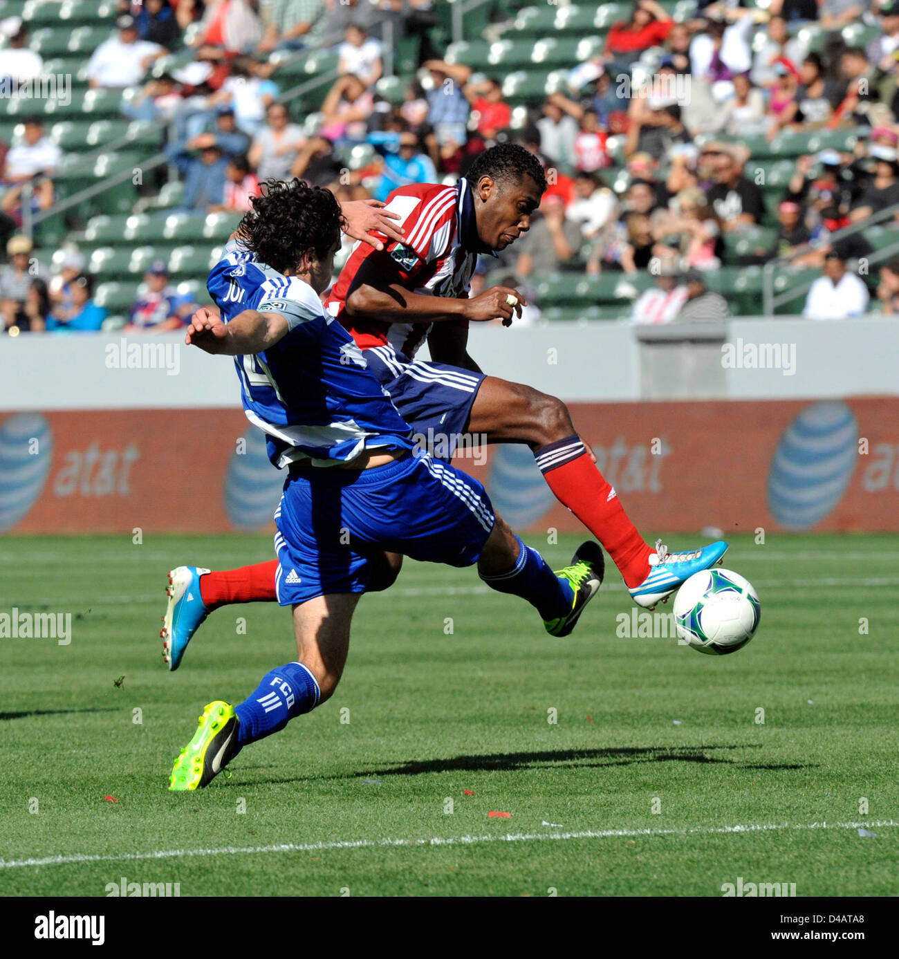 Carson, California, USA. 10th March 2013. CHIVAS USA mid fielder OSWALDO MINDA was not going to be denied his first goal of the season even with heavy pressure being applied by FC Dallas defender GEORGE JOHN during the second half of the match at the Home Depot Center, Carson, California, USA, March 10, 2013.  Chivas USA won the match 3 to 1 for their first win of the season...Credit Image  cr  Scott Mitchell/ZUMA Press (Credit Image: Credit:  Scott Mitchell/ZUMAPRESS.com/Alamy Live News) Stock Photo