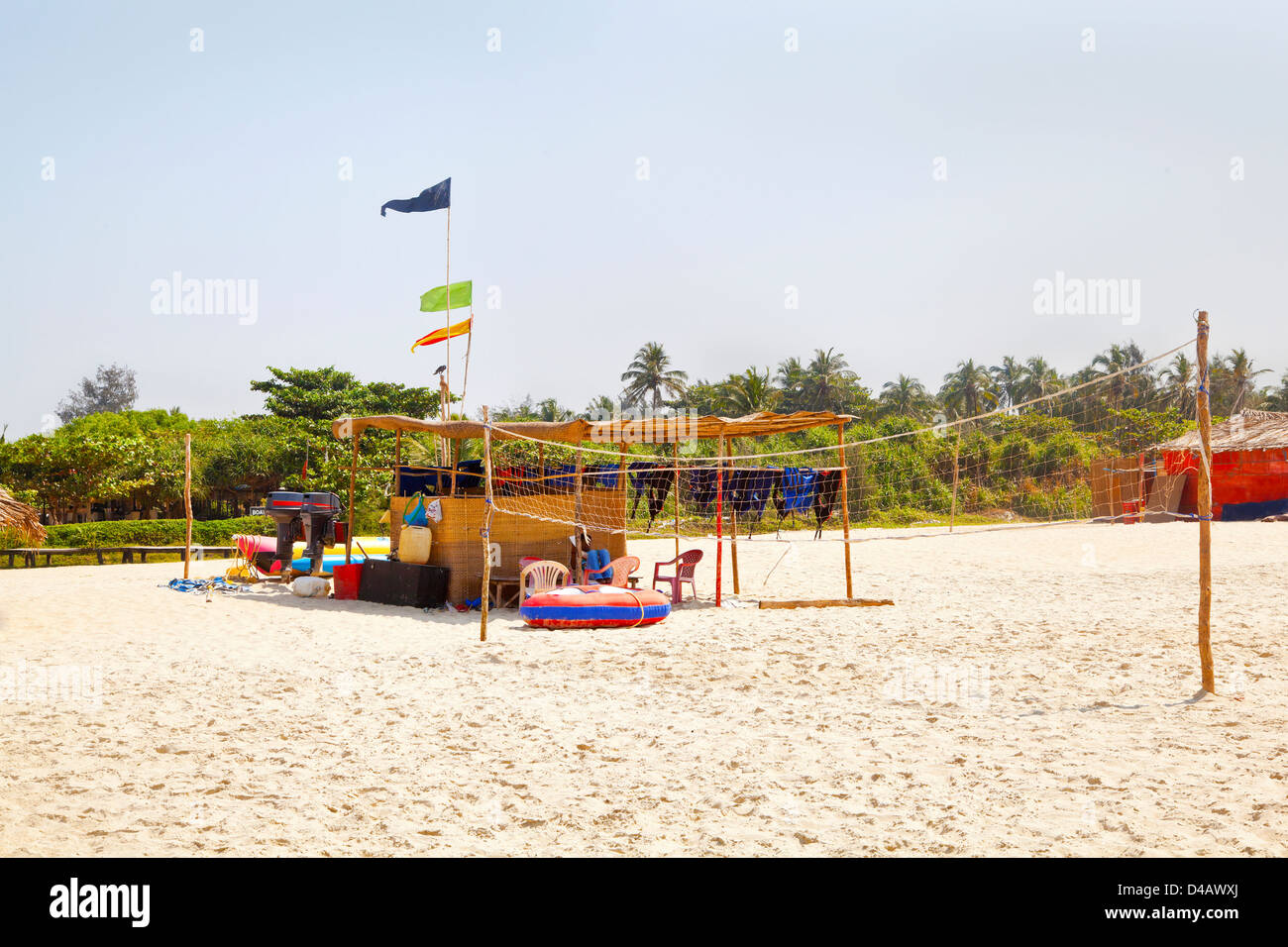 Beach landscape of beach volley ball court net, attendants hut and refreshments shack. A typical beach scene in tropics Stock Photo