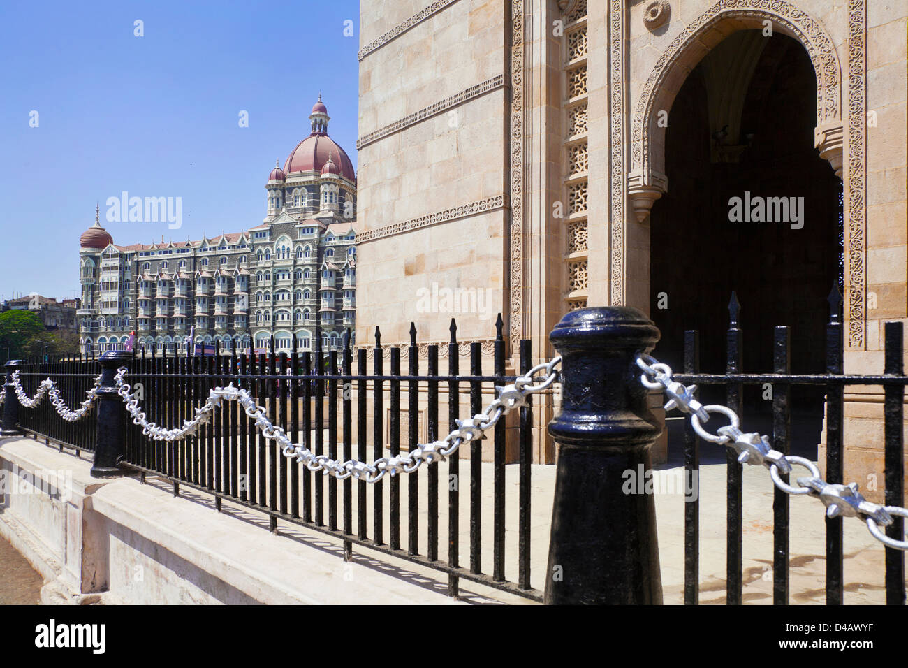 Gateway of India, its black painted railings with a cameo view of the Taj Hotel from an angled view of an archway Stock Photo