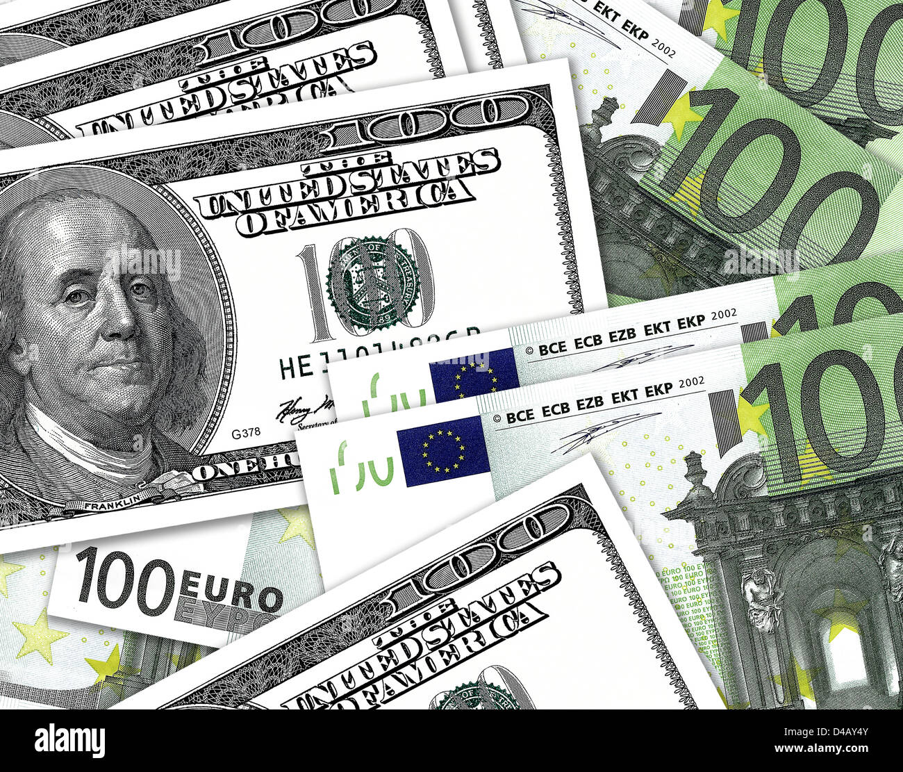 Hundred Dollar notes overlaping hundred Euro notes. $100 and €100 currency bills. Stock Photo