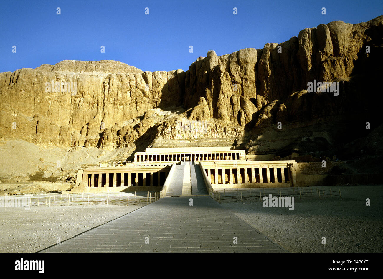 Sun rising on the Temple of Queen Hatshepsut (Foremost of Noble Ladies) at Deir el Bahri on Luxor's West Bank in Egypt. Stock Photo