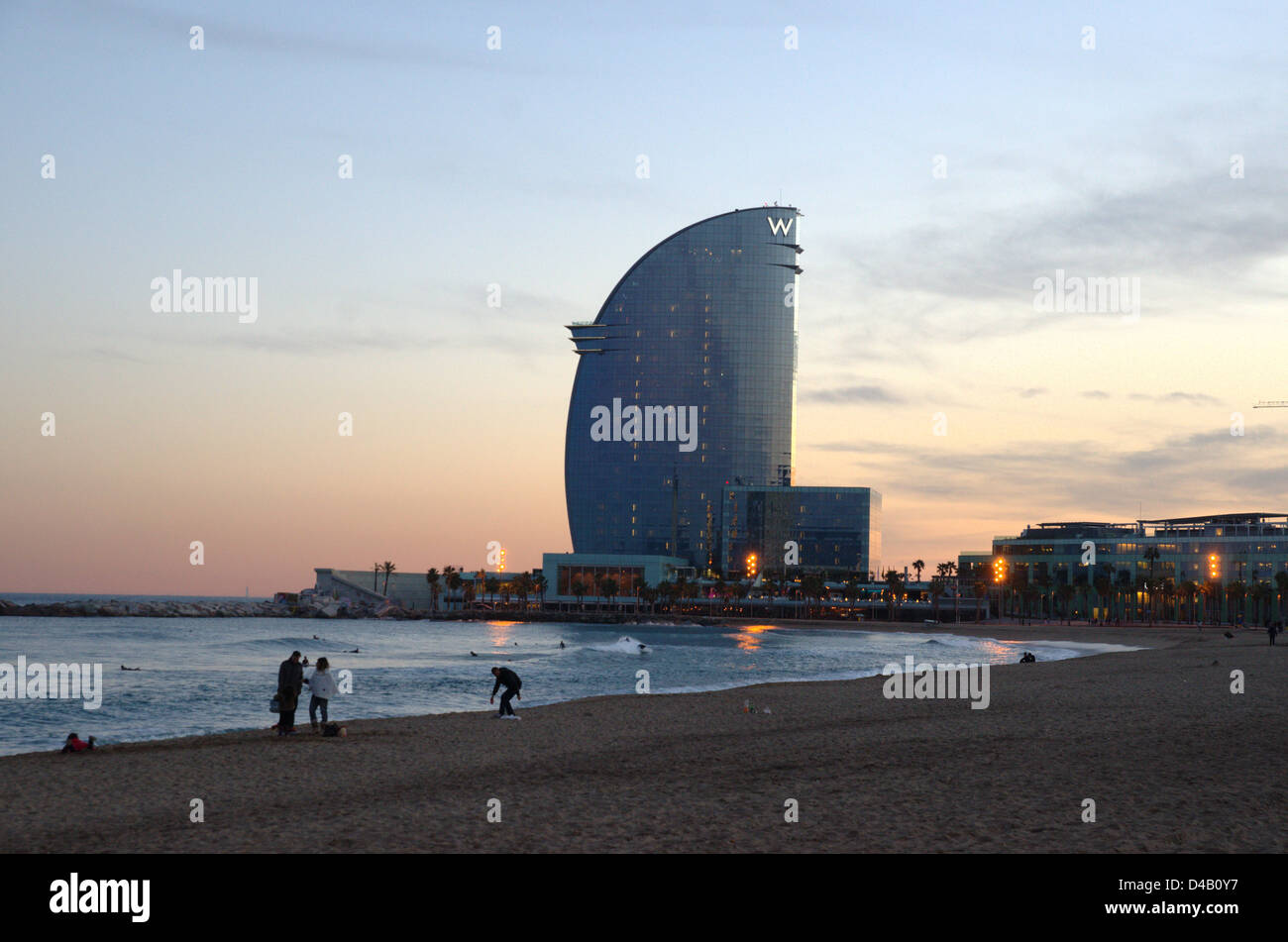 Ambient on the Barcelona beach at night. People watching the sea with W ...