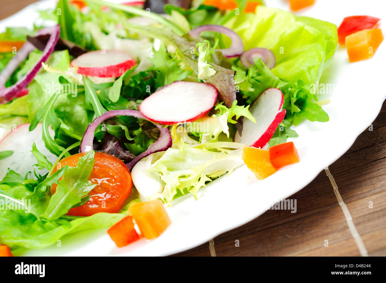 Plate with salad on brown table Stock Photo
