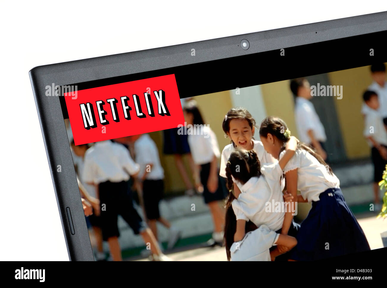 Watching a movie via Netflix online streaming on a laptop computer, UK Stock Photo