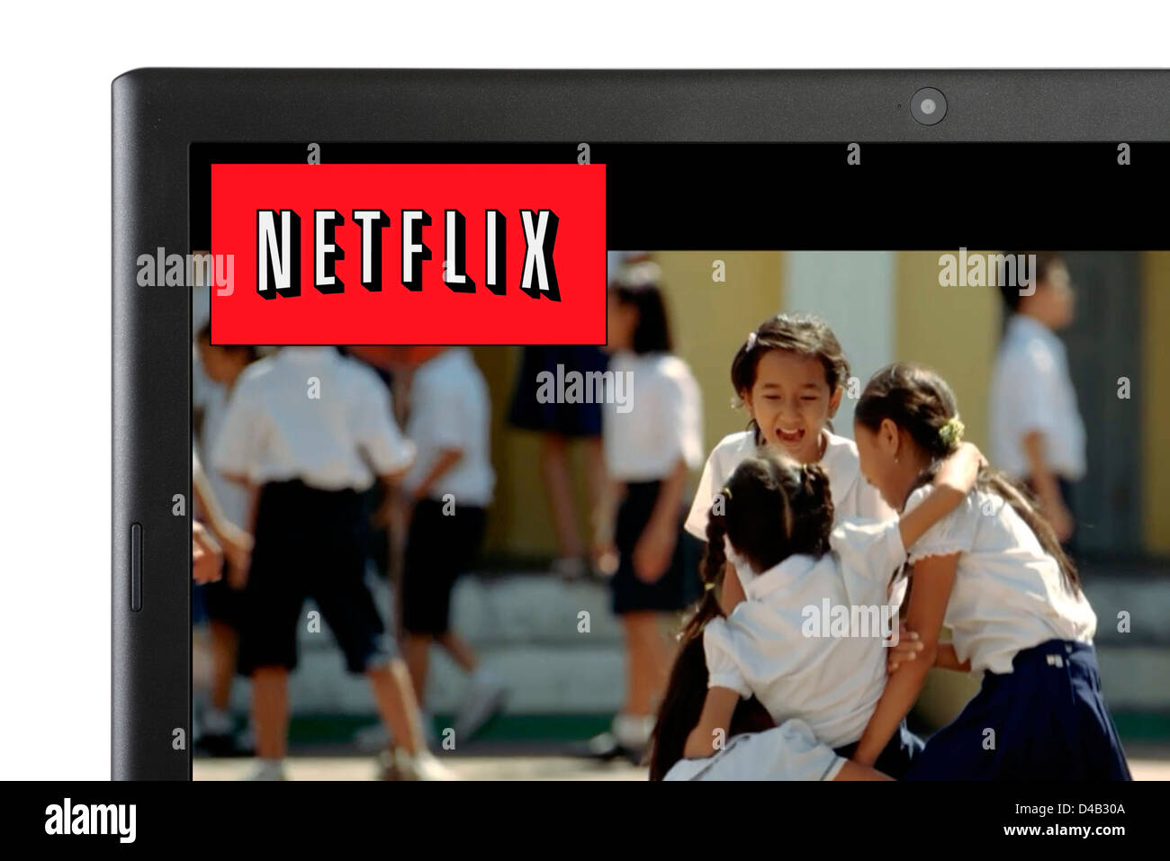 Watching a movie via Netflix online streaming on a laptop computer, UK Stock Photo