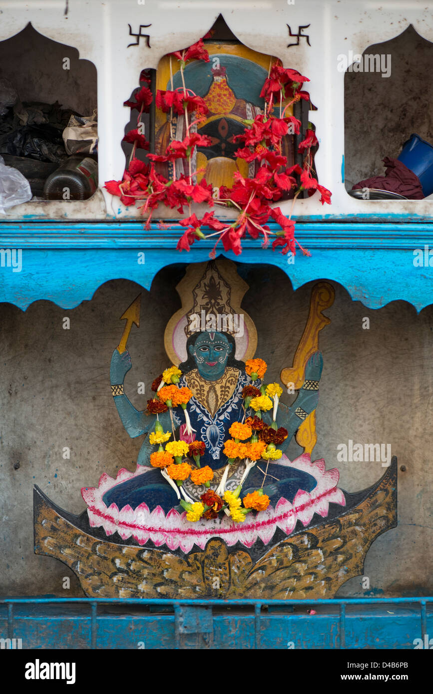 Offerings of flowers adorn a shrine to the Hindu Goddess Kali at Kali