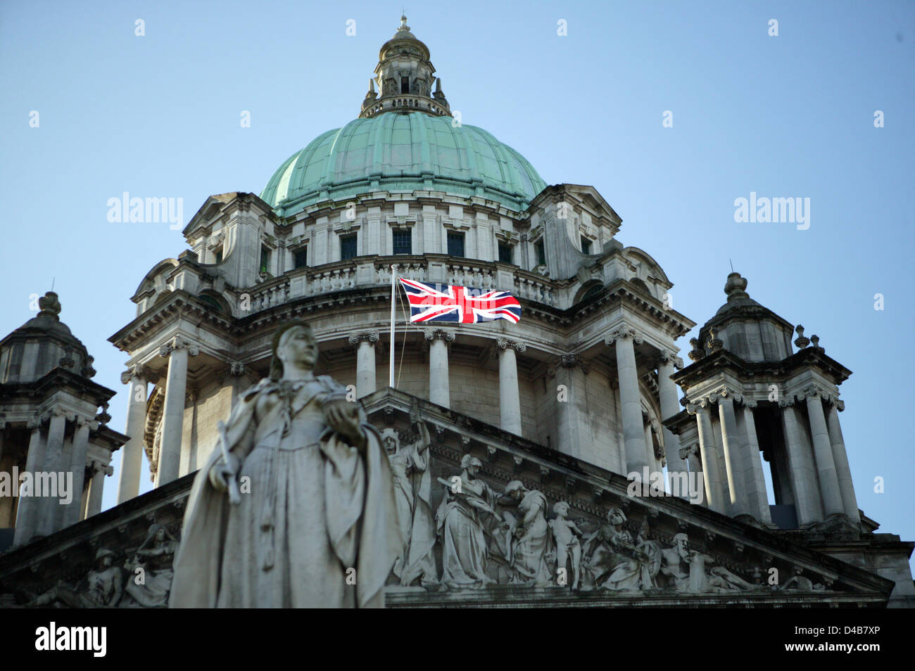 Belfast, UK. 11th March, 2013. To mark Commonwealth Day the Union Flag is flown on Belfast City Hall. This is only one of seveneen days that the Union Flag is flown. The change from 365 days to 17 has caused division in political parties. Belfast City Council took the decision at the council meeting held on the 3rd December 2012. Since then there has been a weekly protest each Saturday outside the grounds of  City hall. Credit:  Bonzo / Alamy Live News Stock Photo