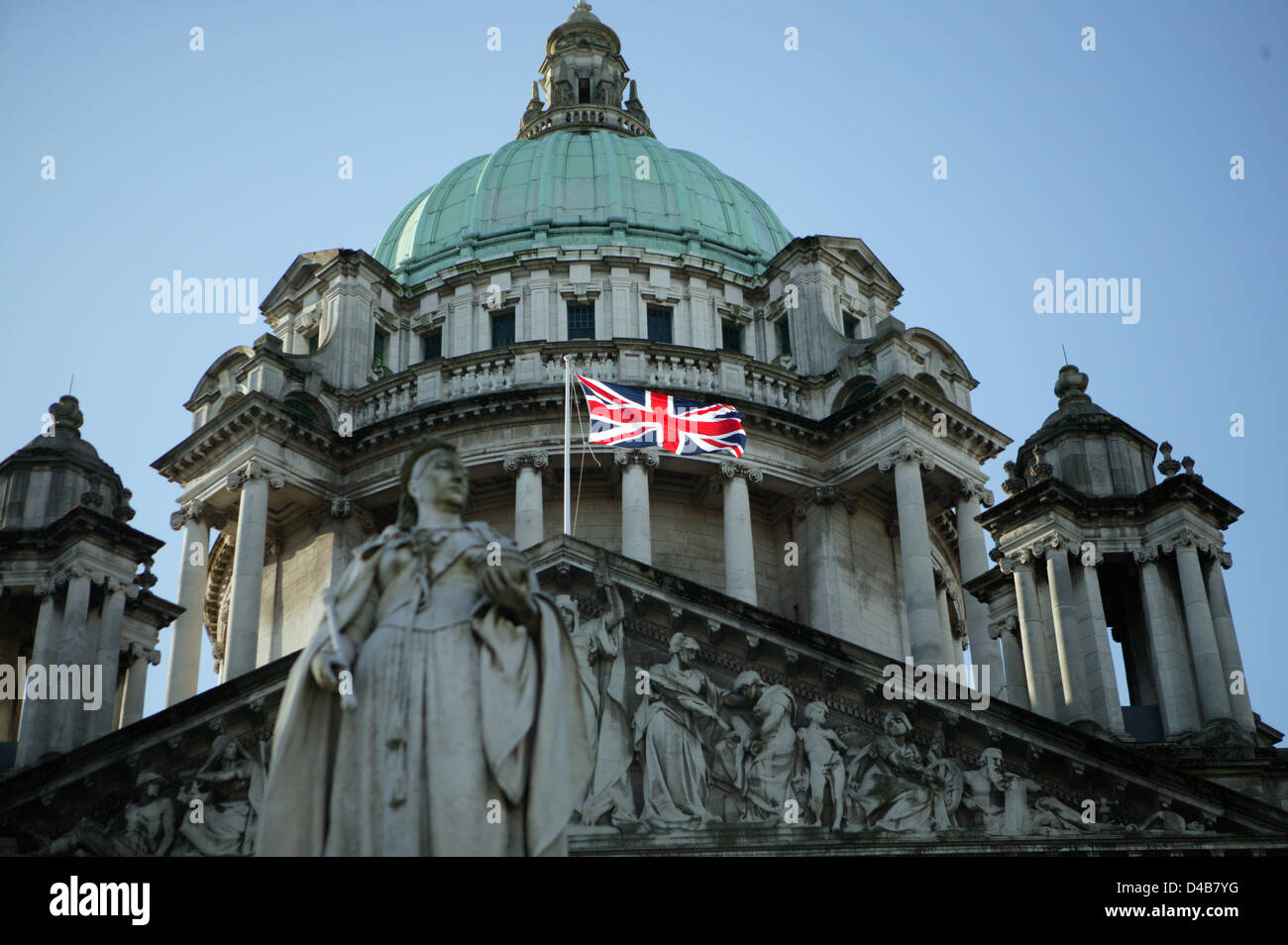 Belfast, UK. 11th March, 2013. To mark Commonwealth Day the Union Flag is flown on Belfast City Hall. This is only one of seventeen days that the Union Flag is flown. The change from 365 days to 17 has caused division in political parties. Belfast City Council took the decision at the council meeting held on the 3rd December 2012. Since then there has been a weekly protest each Saturday outside the grounds of  City hall. Credit:  Bonzo / Alamy Live News Stock Photo