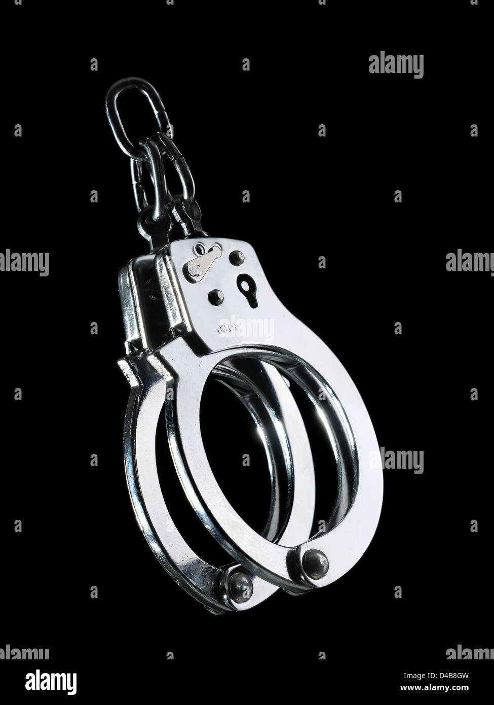 Steel police handcuffs shot on black background Stock Photo