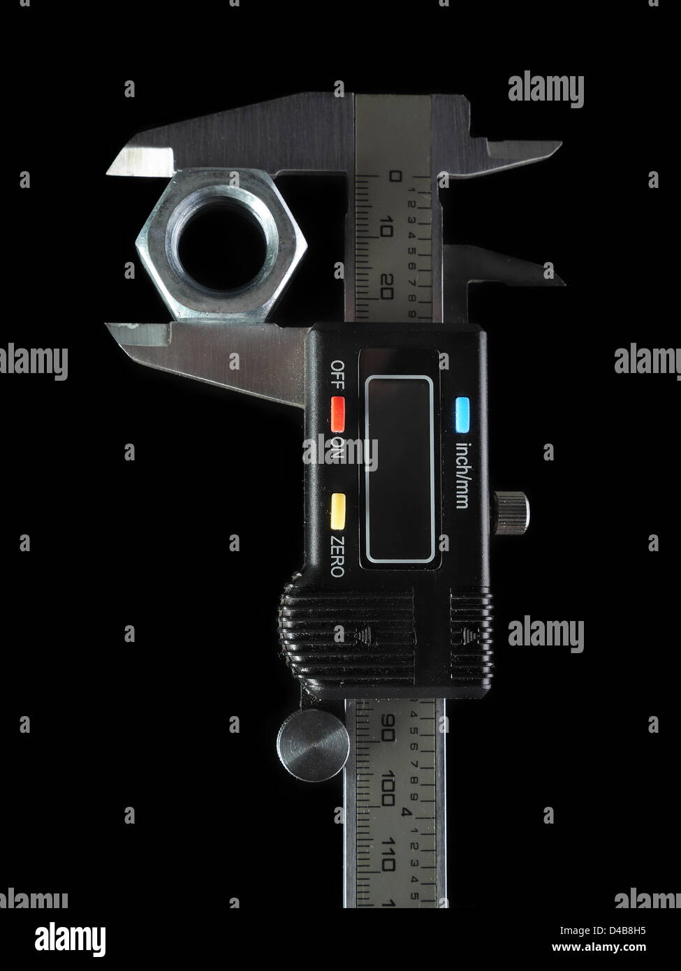 Electronic calipers with bolt nut over black background Stock Photo