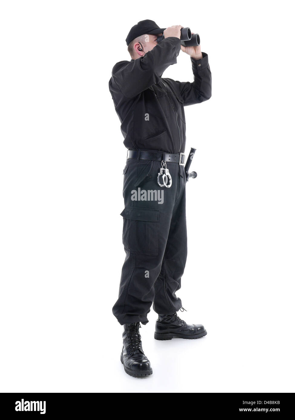 Security man wearing black uniform looking through binocular, shot on white Stock Photo