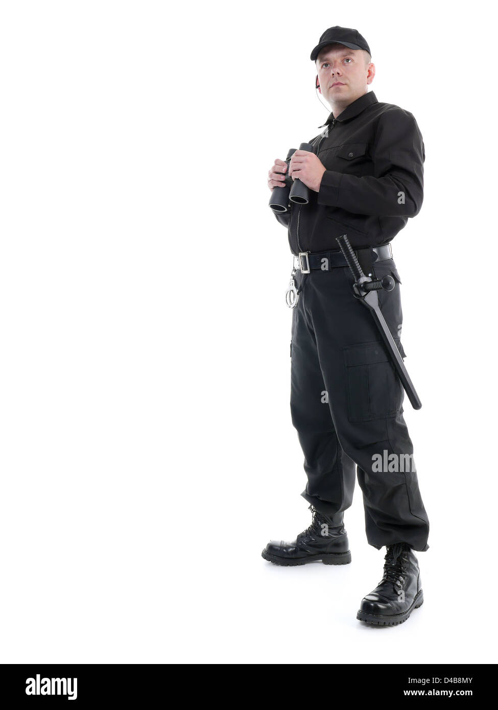 Security man wearing black uniform standing with binoculars, shot on white Stock Photo
