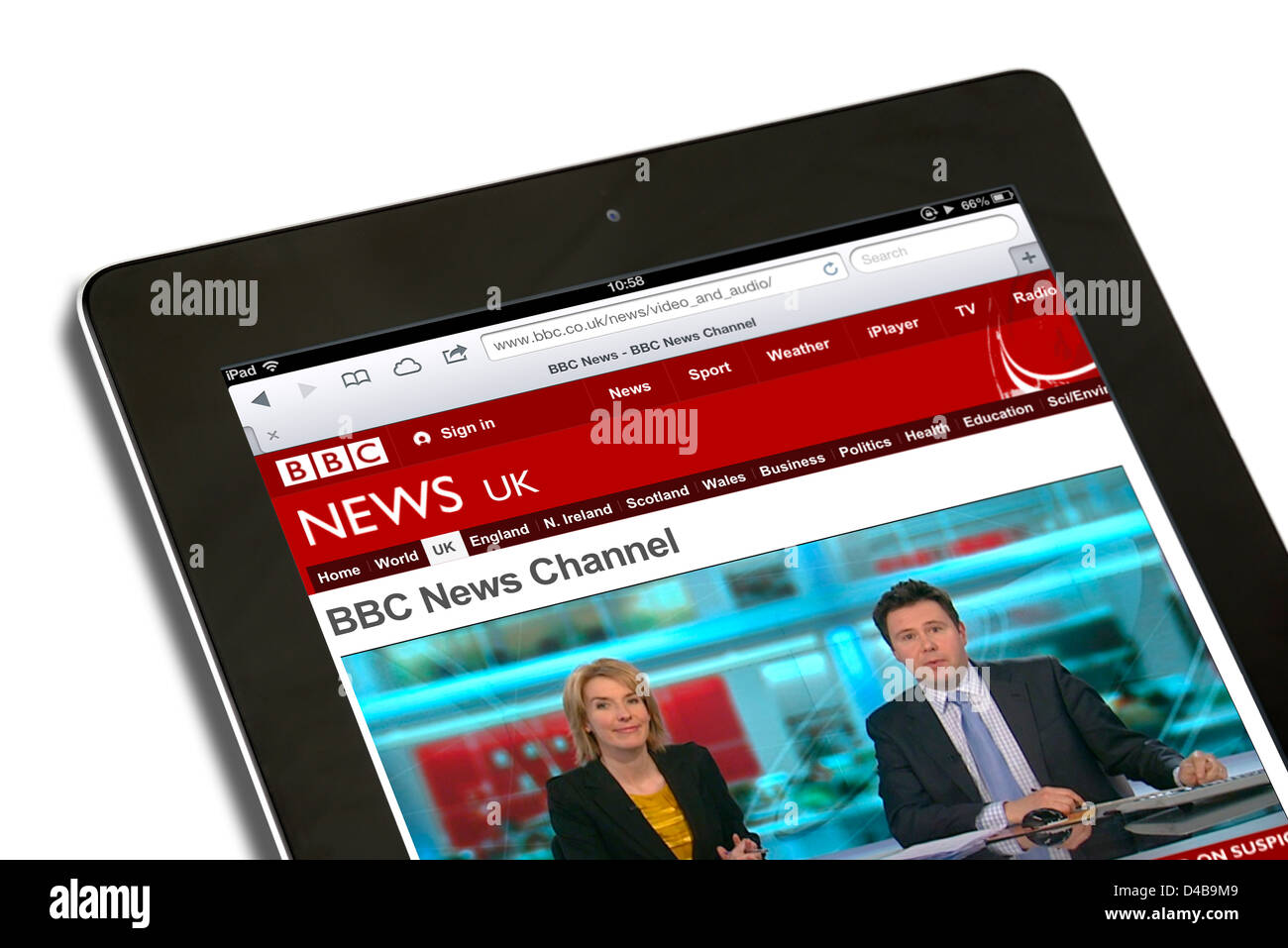 Watching live news on the BBC News channel website on an Apple iPad 4 Stock Photo