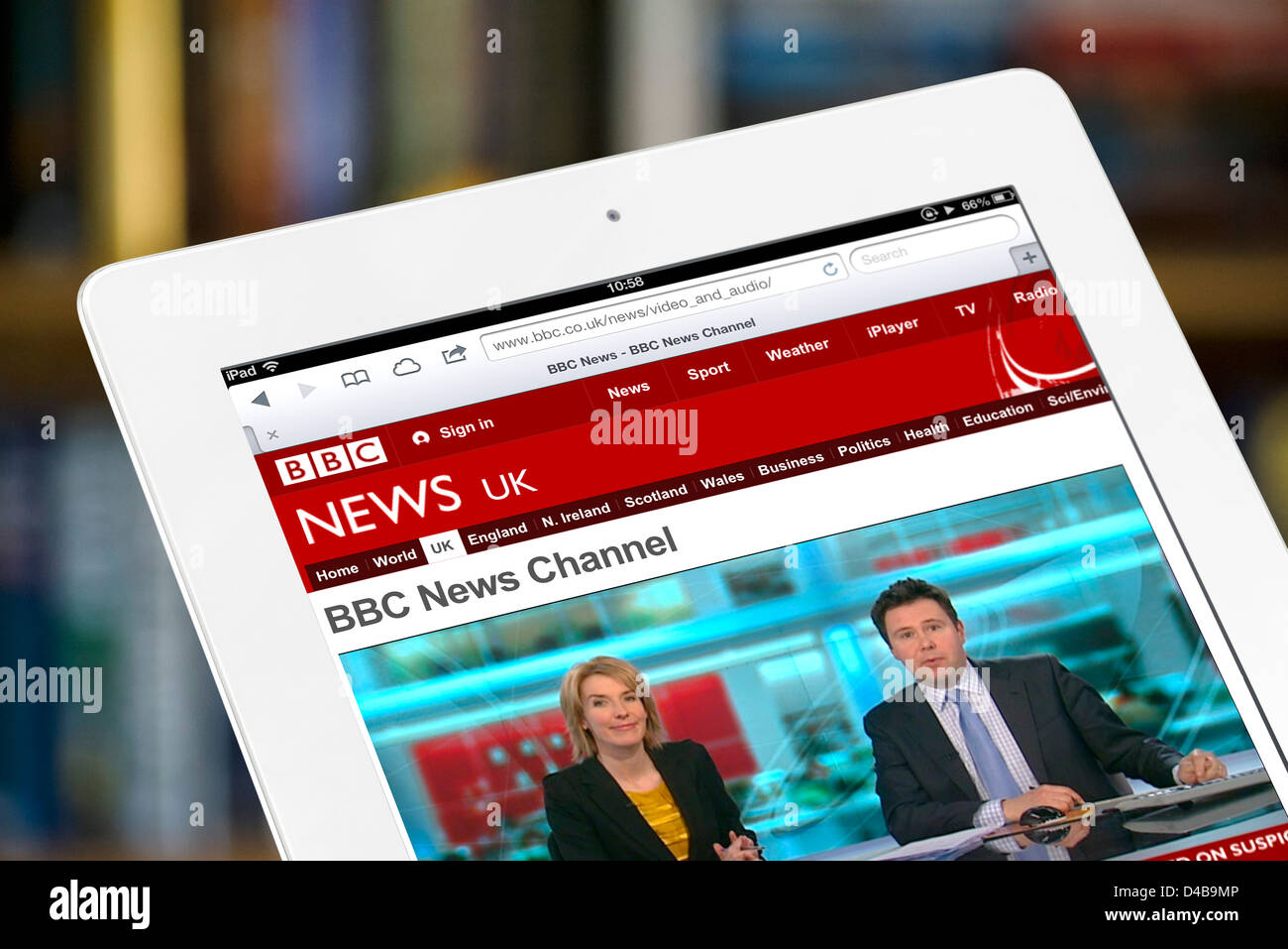 Watching live news on the BBC News channel website on a white Apple iPad 4 Stock Photo