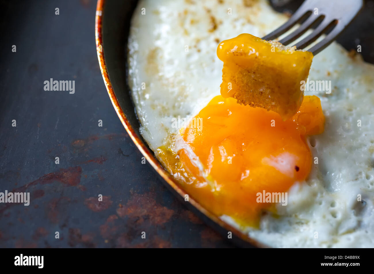 Frying pan full of scramble eggs from two eggs with a small pieces of