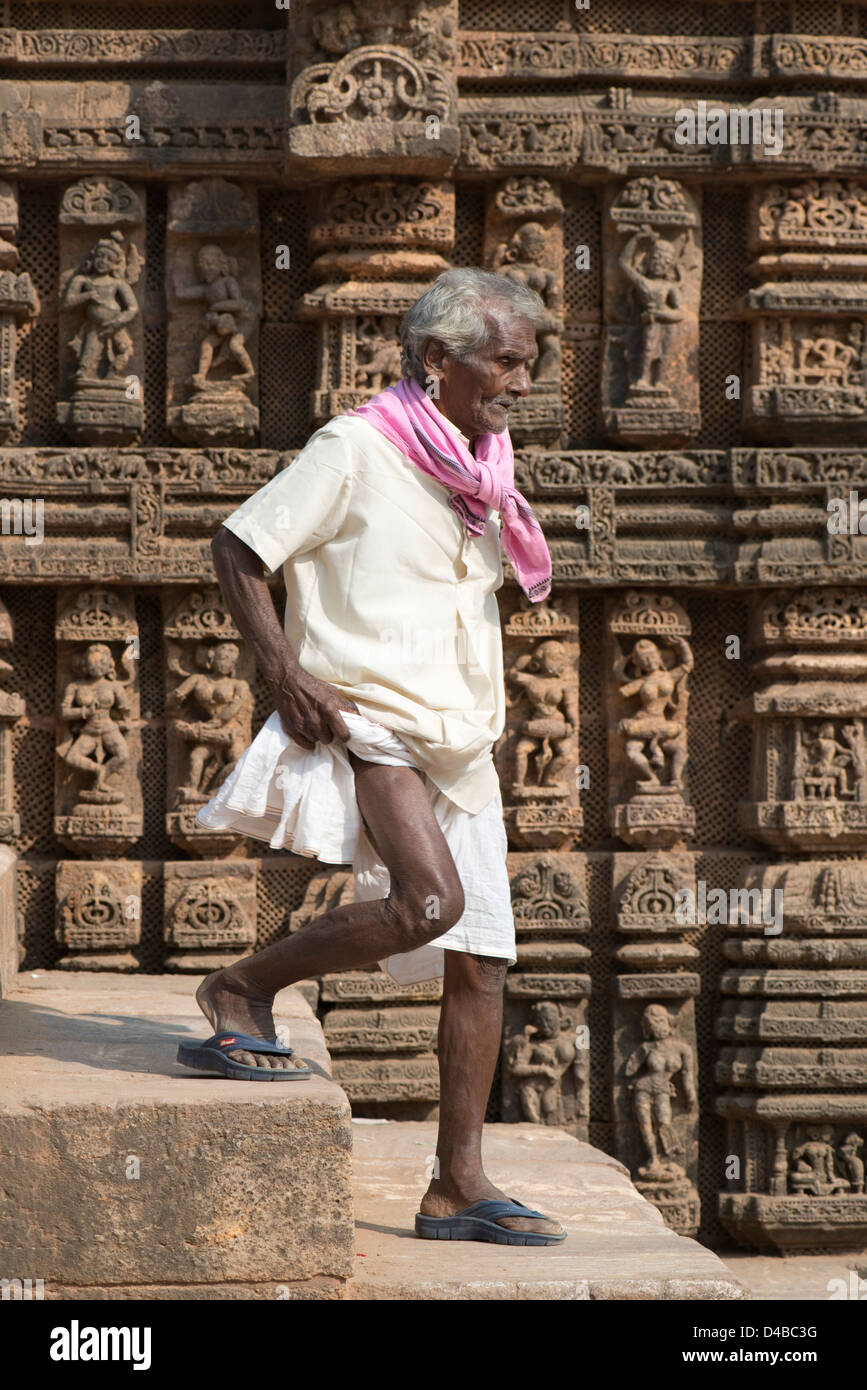 An elderly man in a traditional dhoti descends steps at the Konark Sun Temple near Puri, Odisha state, India Stock Photo