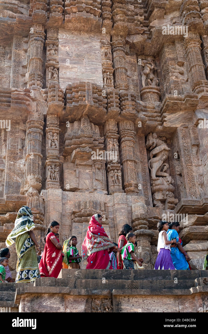 A group of tourists pass a façade of the Konark Sun Temple near Puri, Odisha state, India Stock Photo