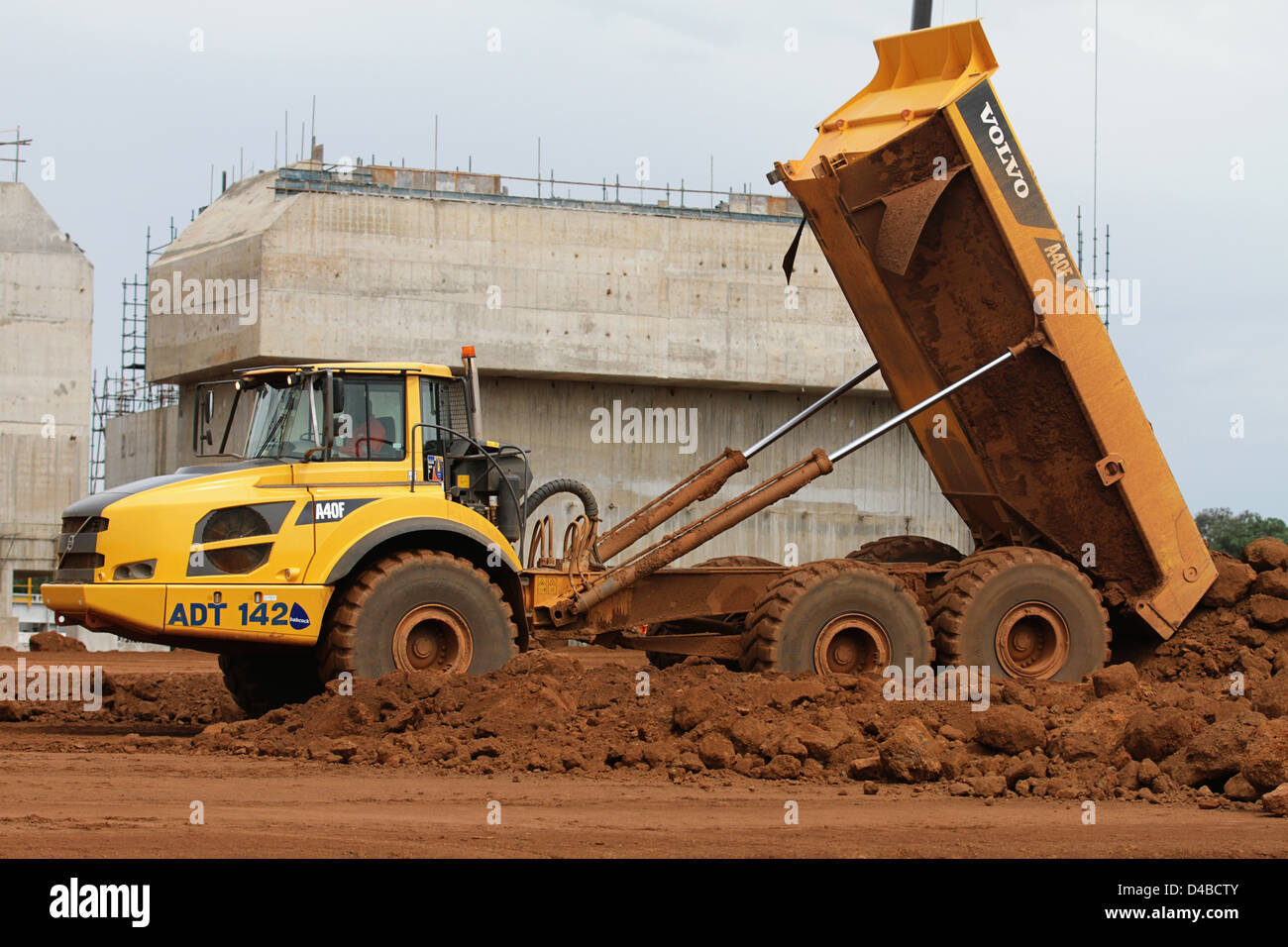 Volvo A40F Articulated Dump Truck in action tipping earth on the Sentinel mining construction site Stock Photo