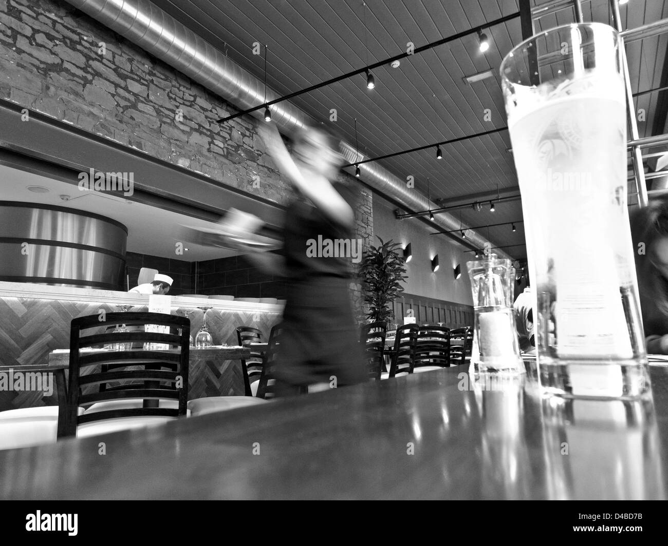 Bar restaurant busy waitress in blurred motion. Stock Photo