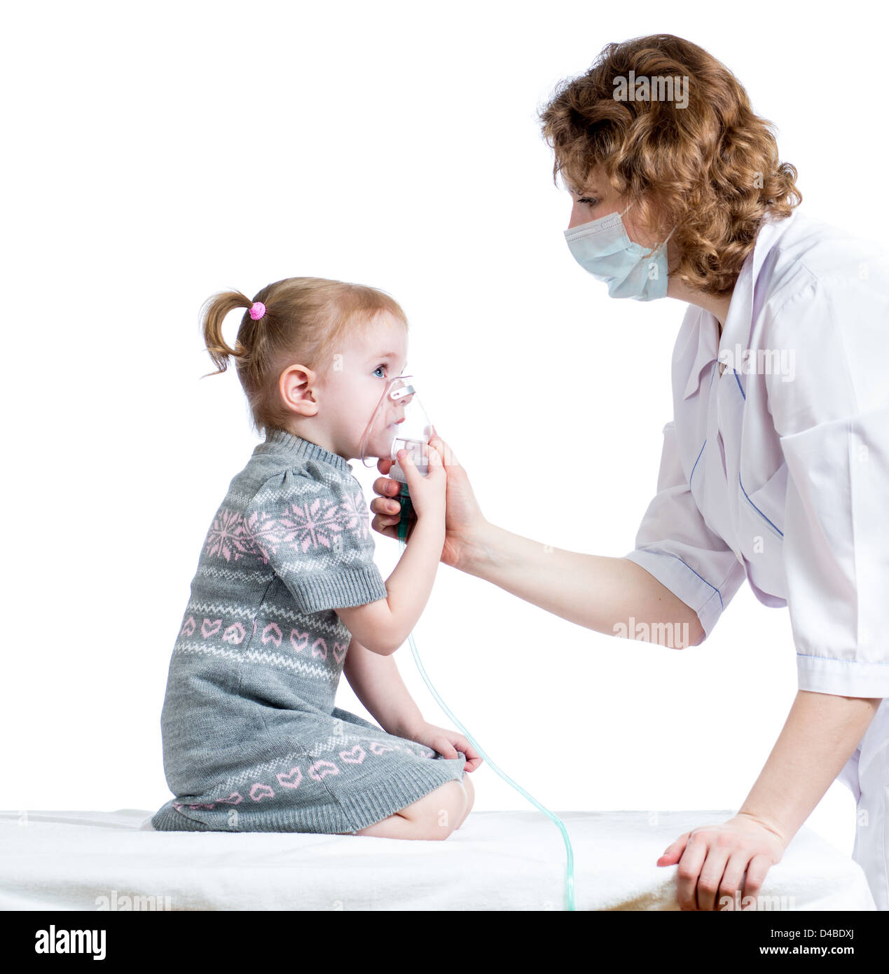 Doctor holding inhaler mask for kid breathing, hospital Stock Photo