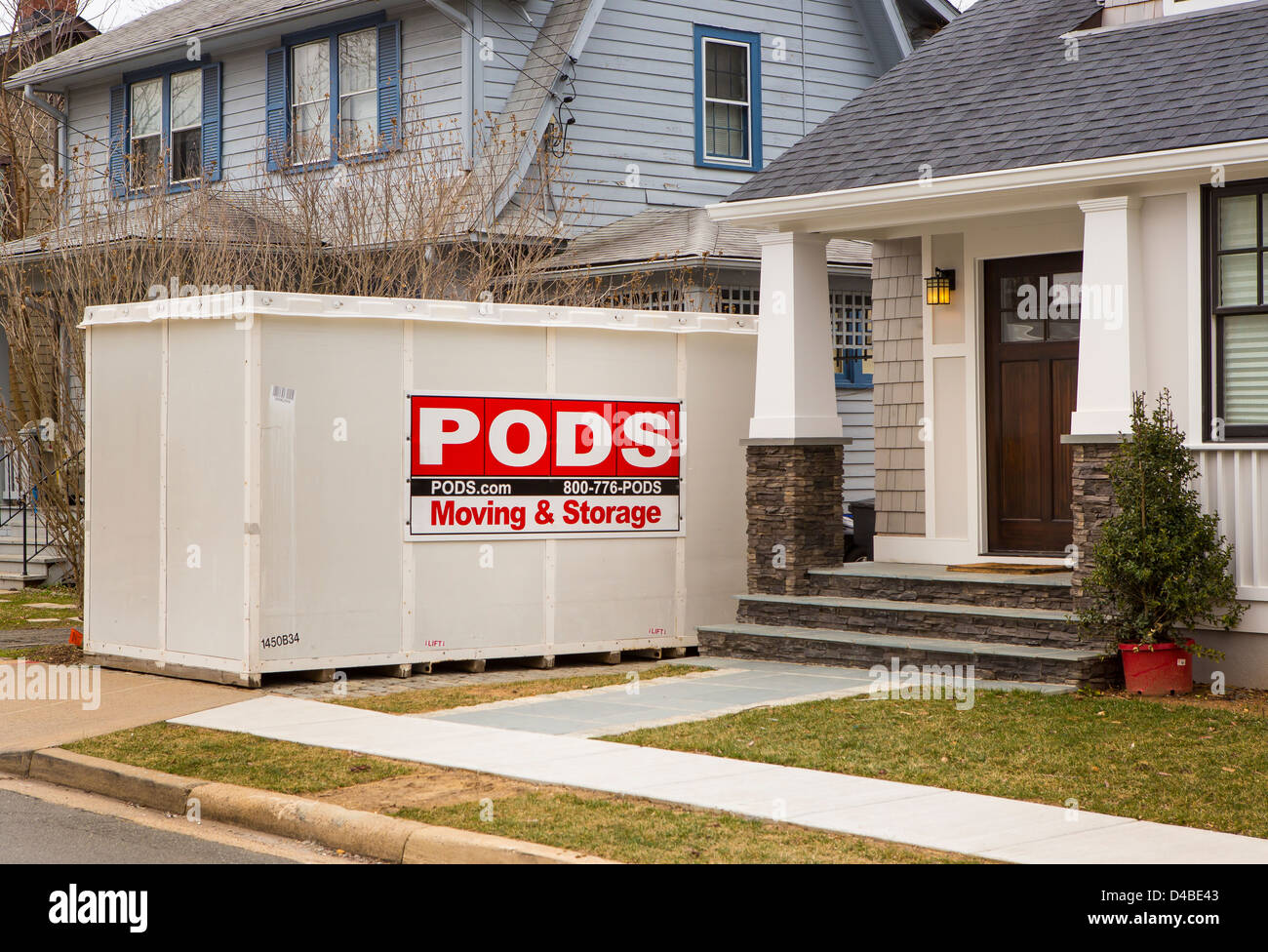 ARLINGTON, VIRGINIA, USA - PODS storage container in front of houses. Stock Photo
