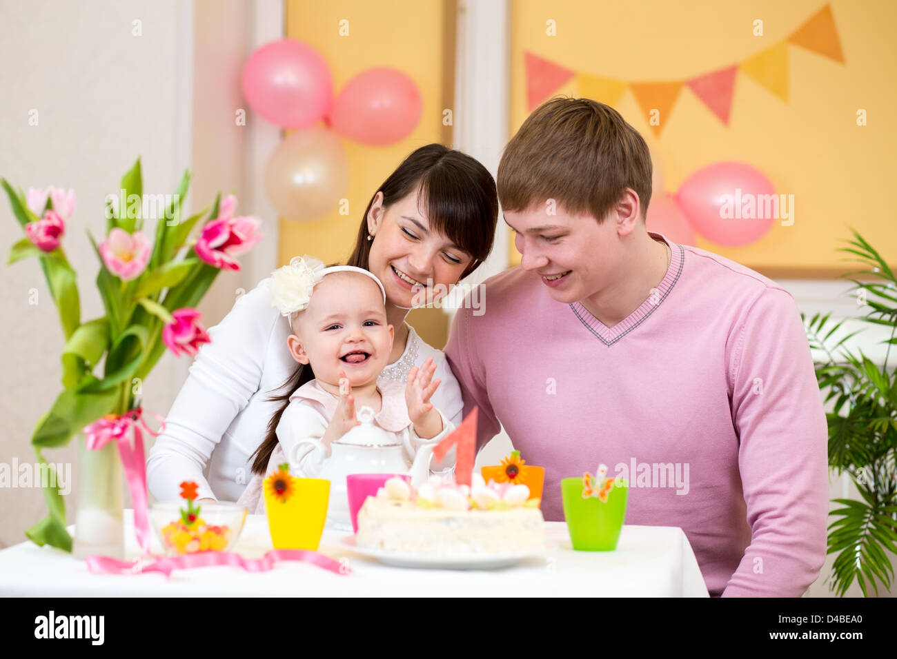 family celebrating first birthday of baby daughter Stock Photo - Alamy