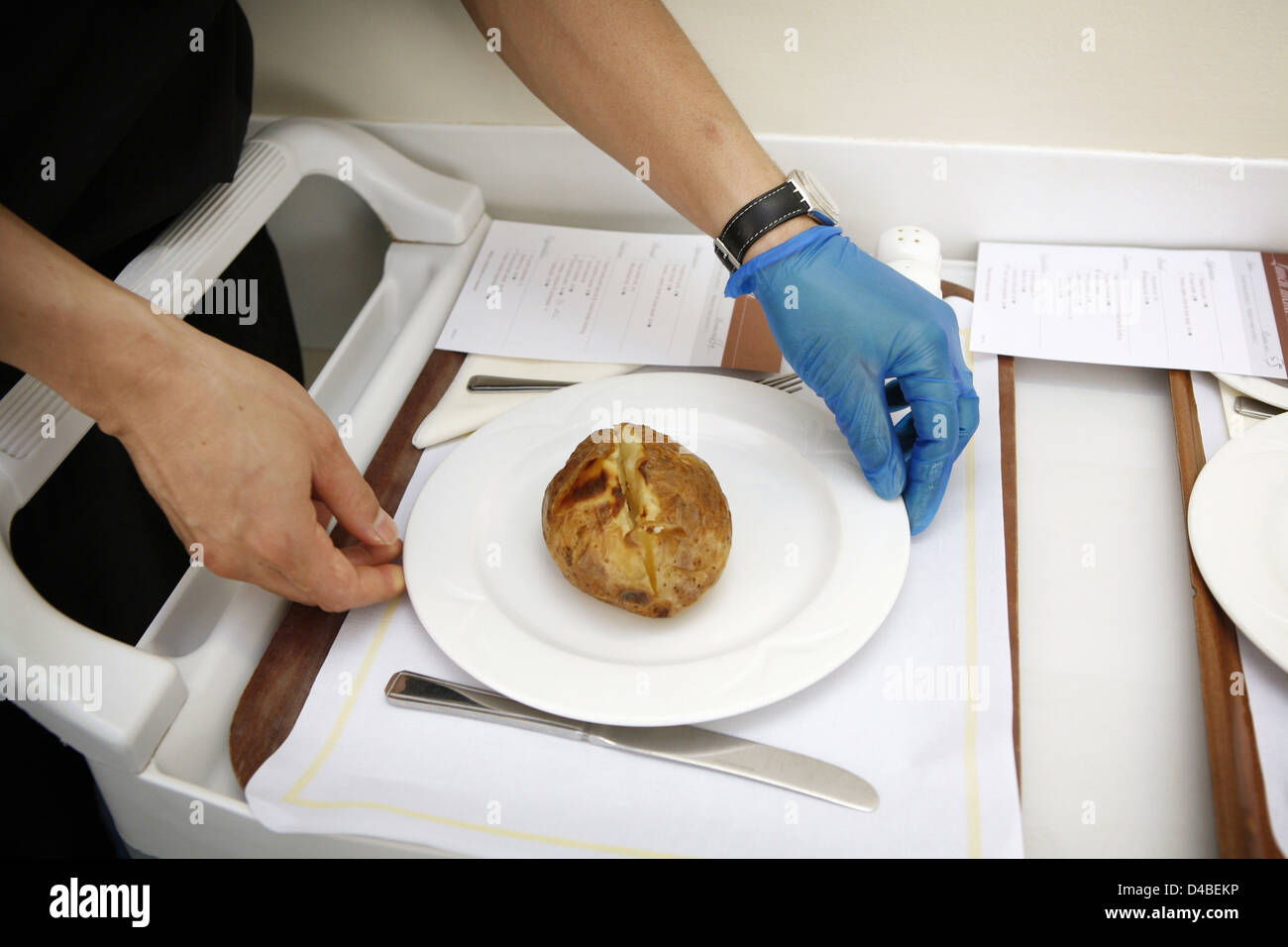 Hospital caterer preparing food tray for hospital patient Stock Photo