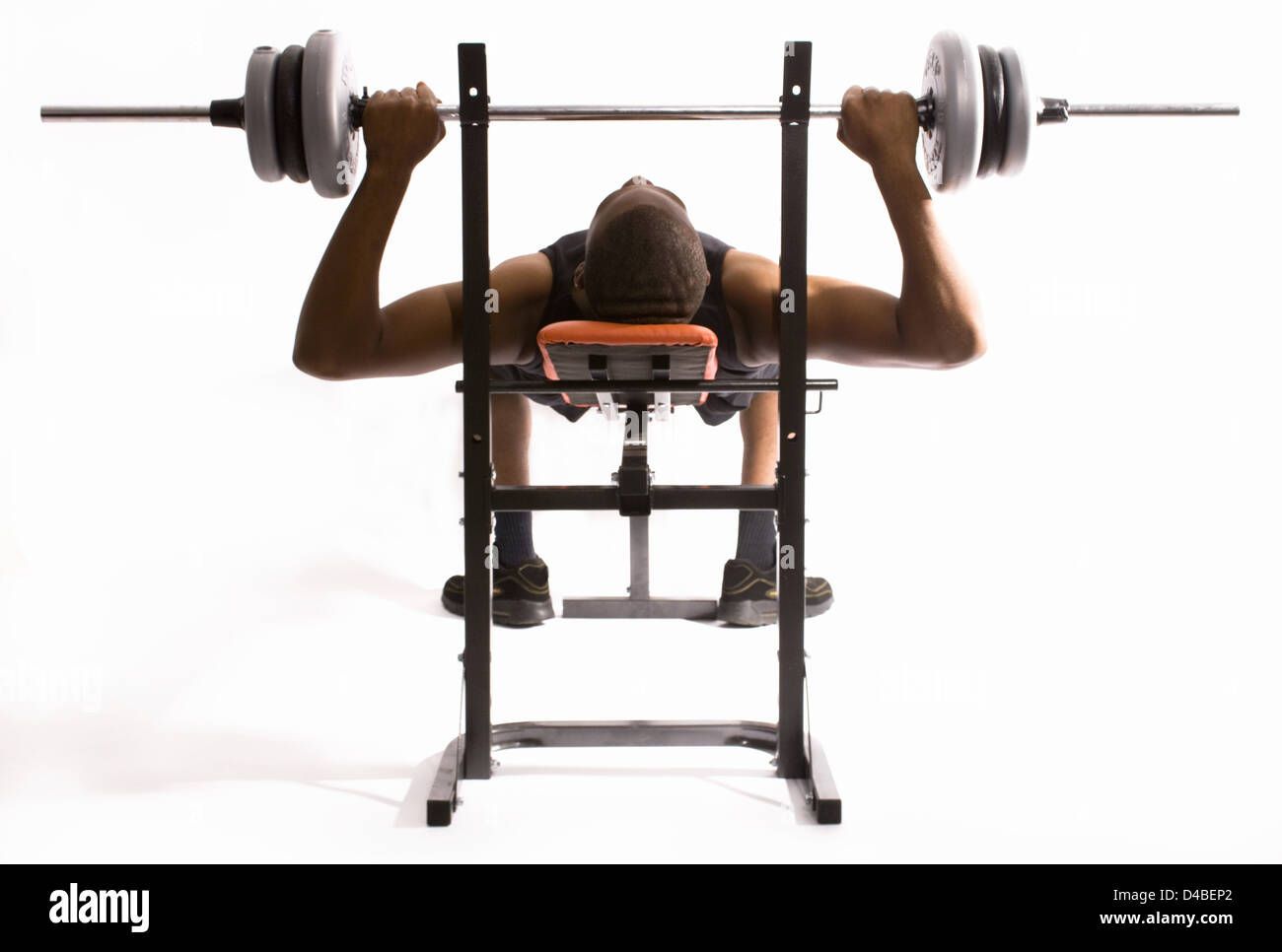Man Performing Bench Press Exercise Using Specialist Weight