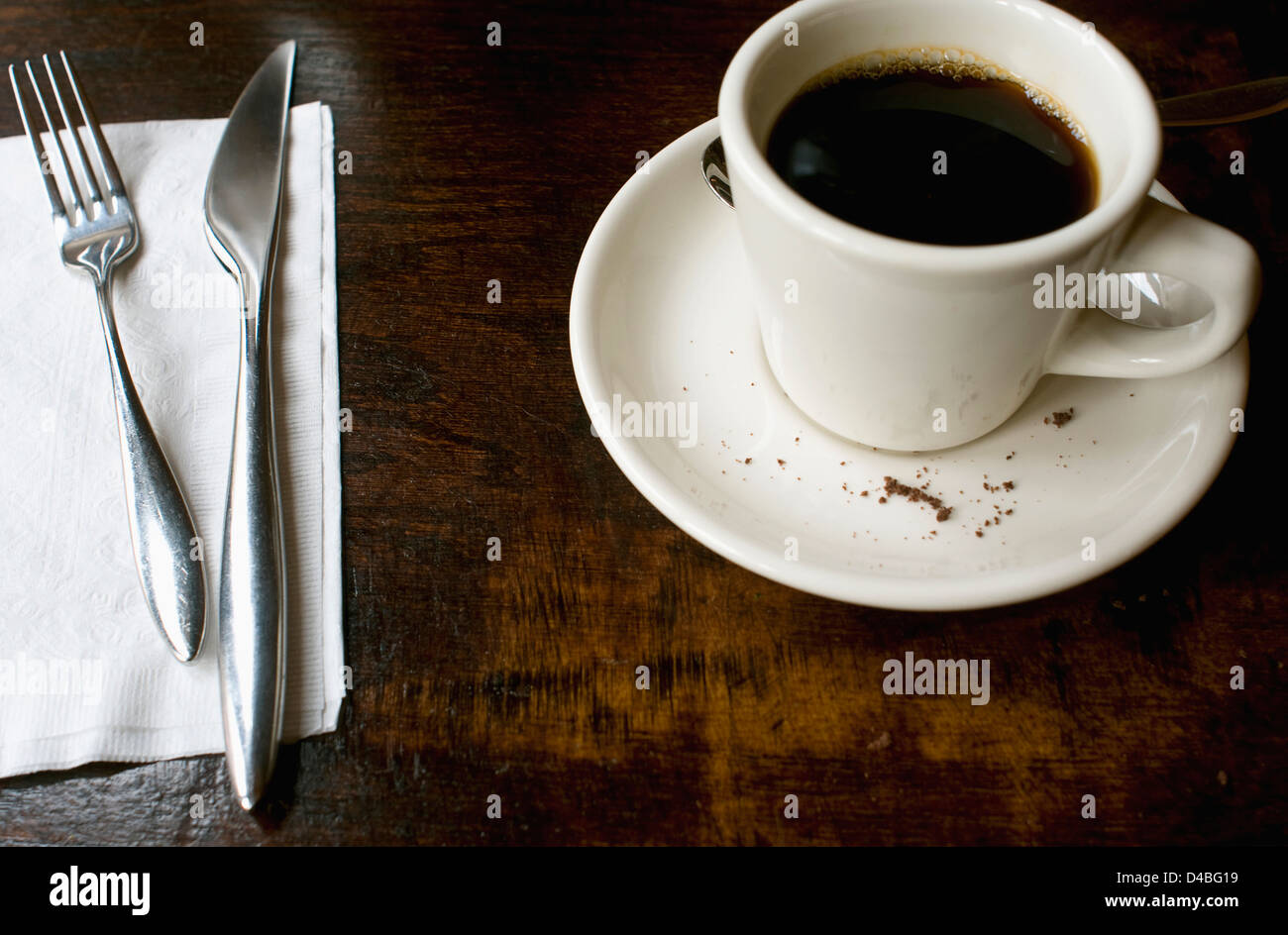 A cup of coffee on a saucer filled with crumbs Stock Photo Alamy
