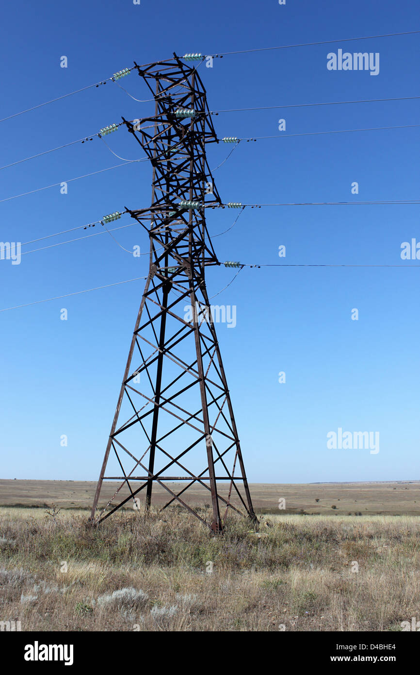 high voltage electricity pylon over blue sky Stock Photo - Alamy