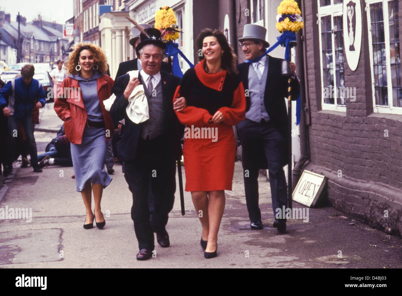 The Tuttimen & Orangeman escort two young women to the Hocktide luncheon Hocktide Ceremony annual custom celebrated at Hungerford Berkshire England UK Stock Photo