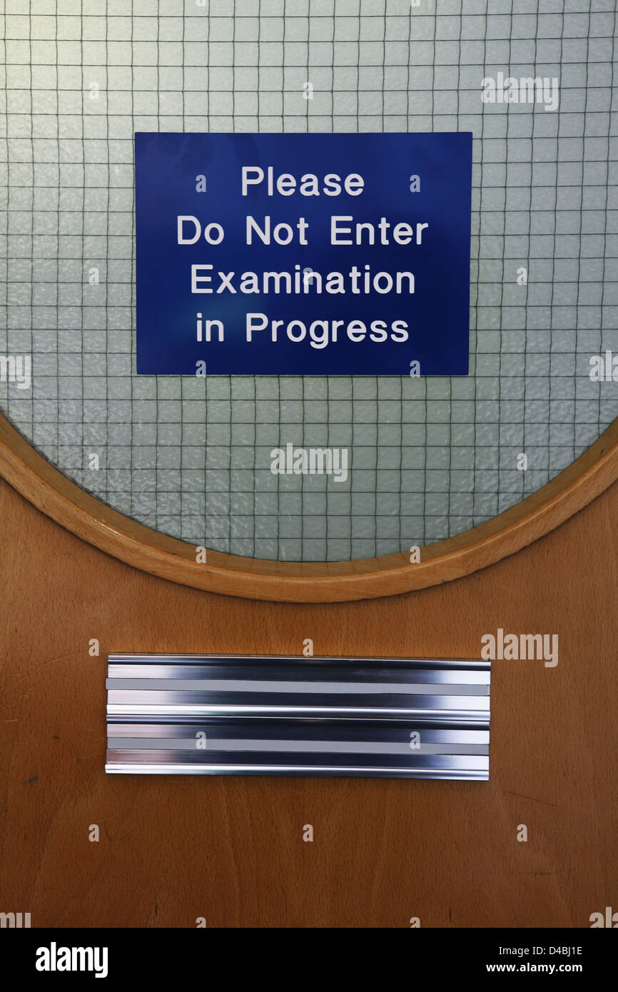 Please Do Not Enter Examination in Progress sign on door Stock Photo