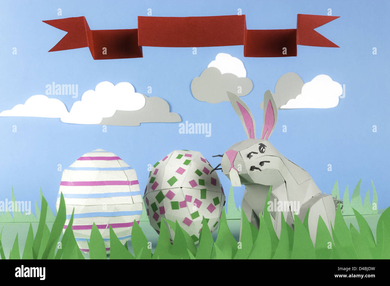 Rabbit made of paper in a happy paper environment and a ribbon with ...
