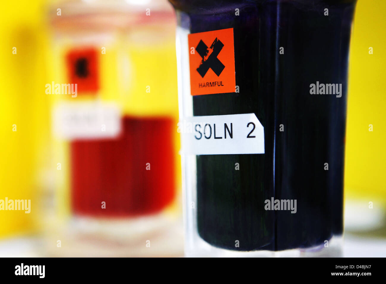 Close up of harmful warning label on various glass bottles containing