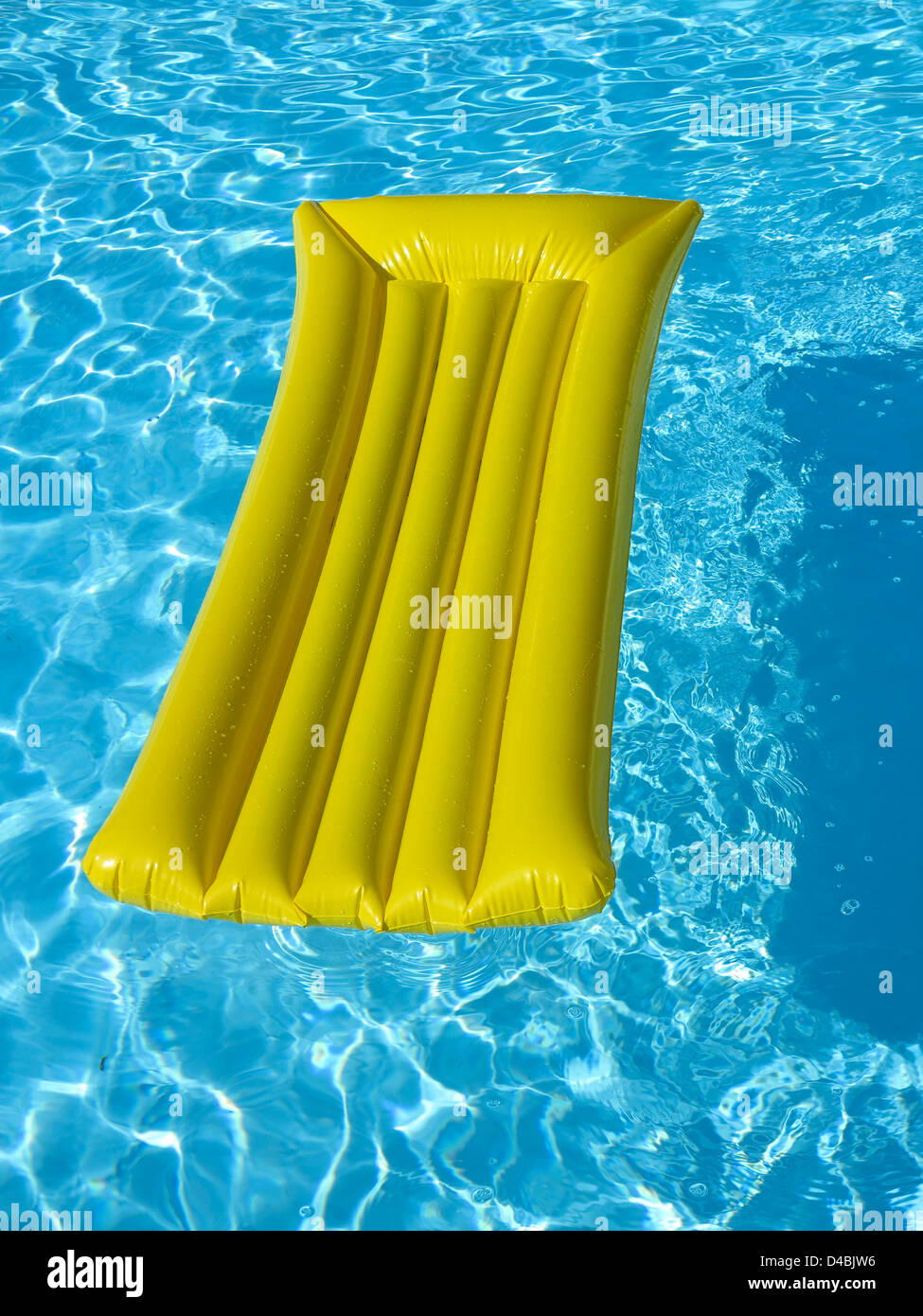 Lilo / inflatable air bed mattress in a swimming pool Stock Photo