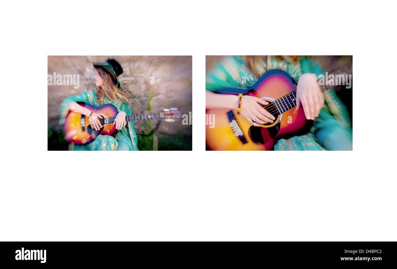 A white European female age 20-25 wearing hippie style clothing and playing a guitar, the image was shot on location in the UK. Stock Photo