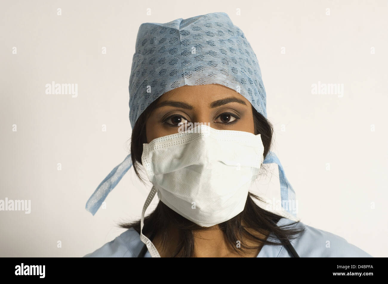 Studio portrait of female surgeon wearing hygiene mask and hat Stock ...