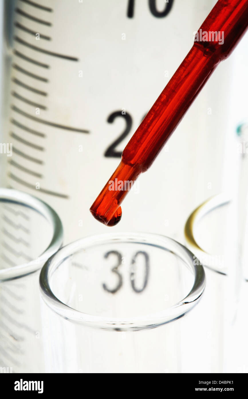 Pipetting red liquid into test tubes Stock Photo - Alamy