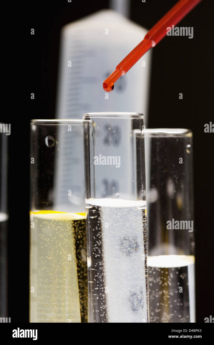 Pipetting red liquid into test tubes Stock Photo - Alamy