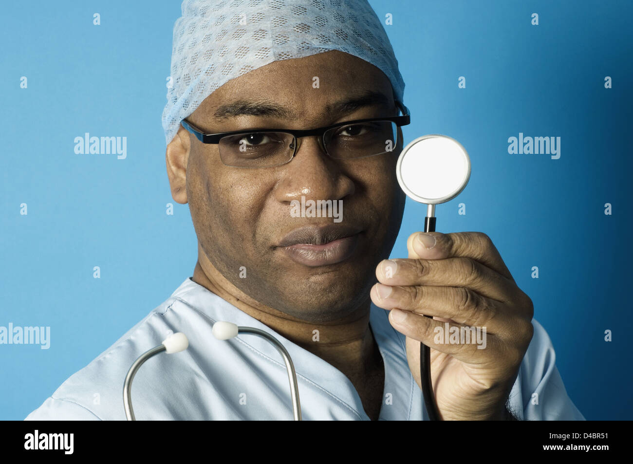 Portrait of surgeon in scrubs holding stethoscope Stock Photo