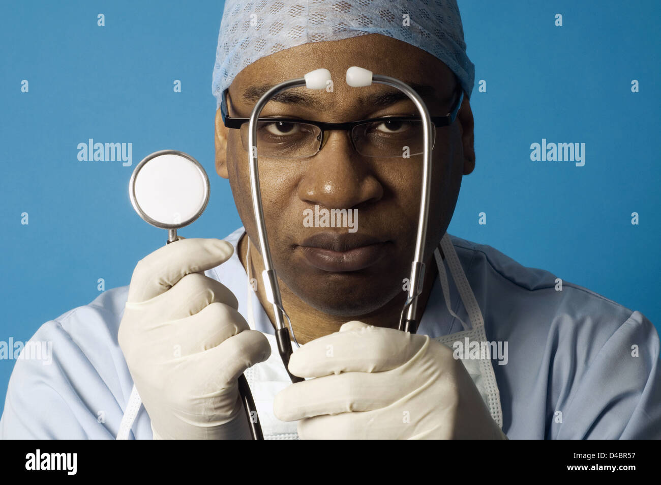 Portrait of surgeon in scrubs holding stethoscope Stock Photo