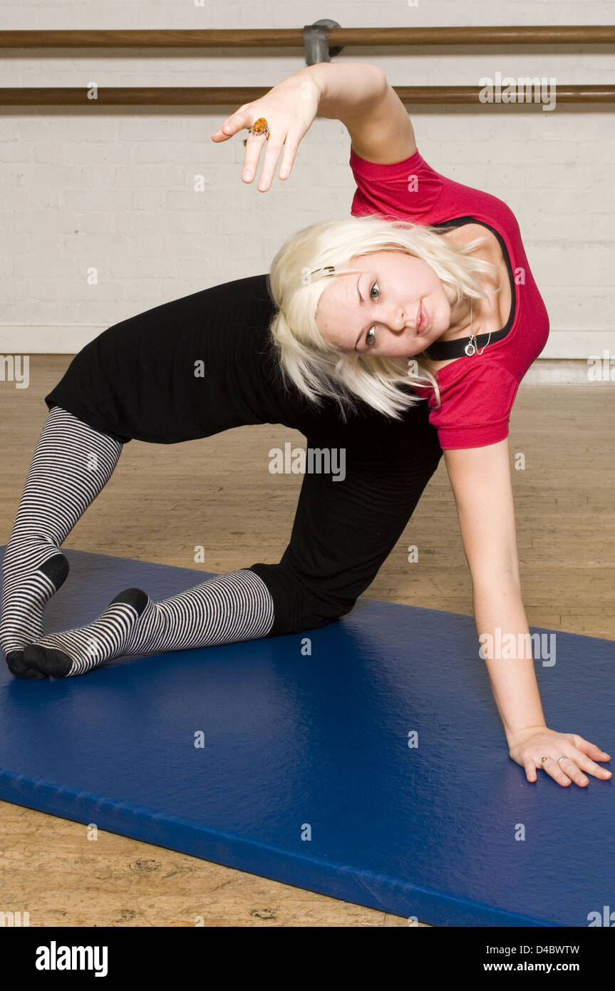 An exercise class Body Control Centre in London perform Pilates Advanced Mermaid routine Pilates physical fitness system Stock Photo
