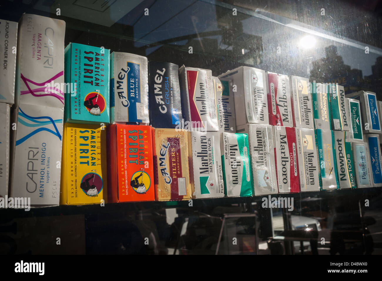 Cartons of cigarettes in the window of a grocery store in New York on Saturday, March 8, 2013. (© Richard B. Levine) Stock Photo