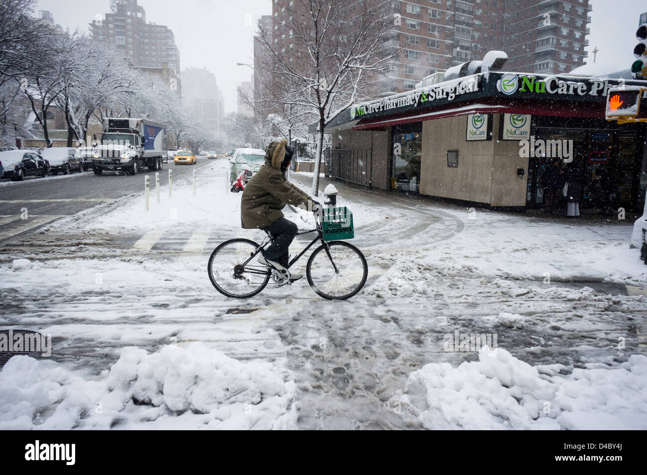 A bicyclist travels on a snow-covered bike path in the Chelsea ...