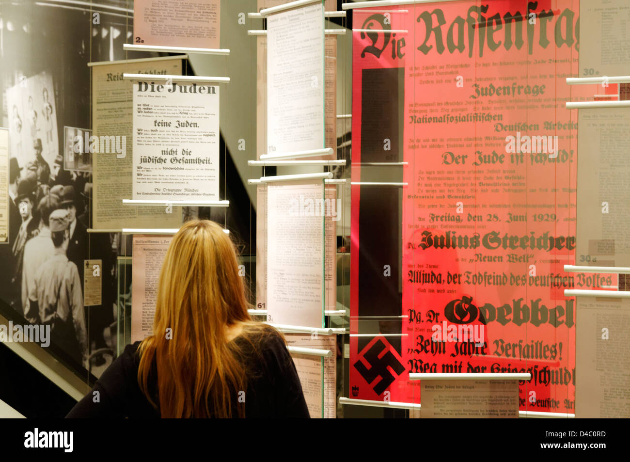 A young woman looking at a nazi era display in The Jewish Museum in Berlin Stock Photo