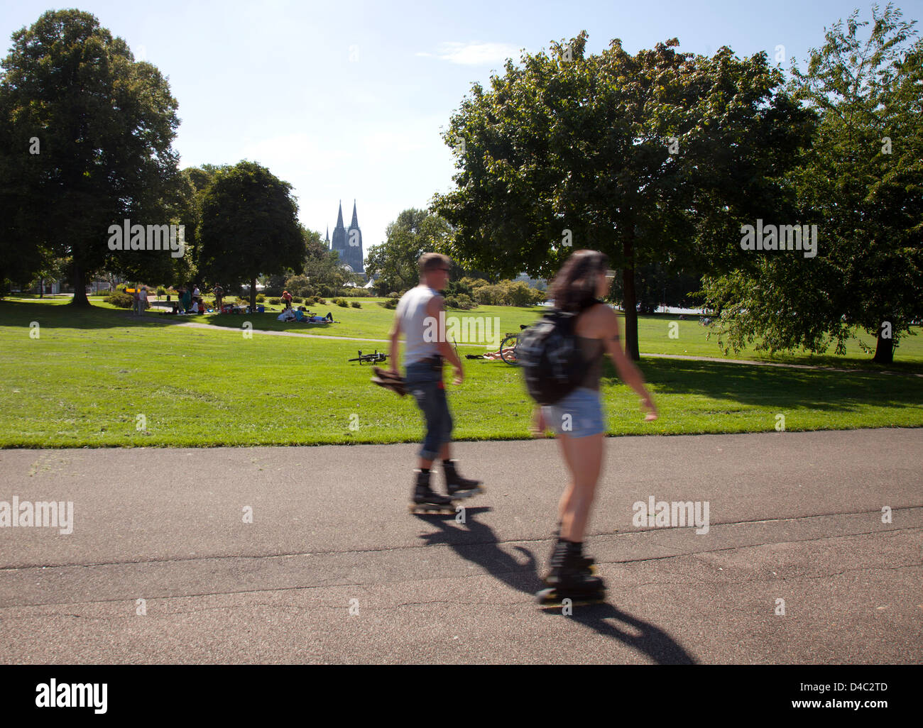 Koeln, Germany, inline skaters in the Rhine Park on Cologne Cathedral Stock Photo