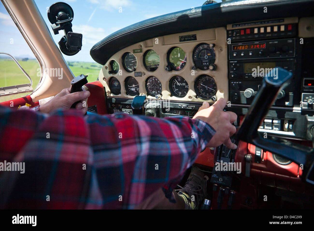 A pilot at the controls of a light aircraft, taxiing and preparing for take off. Stock Photo